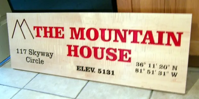 wood carved house sign